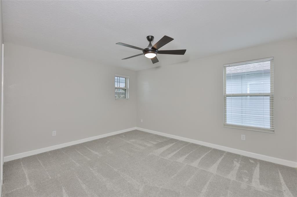 11454 Freshwater Ridge Drive Riverview, FL 33569 - Photo 46 of 65 an empty room with a window and a fan