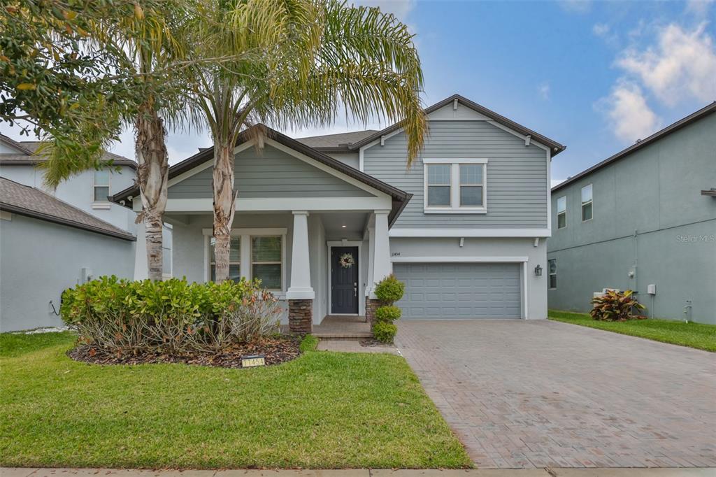 11454 Freshwater Ridge Drive Riverview, FL 33569 - Photo 5 of 65 a front view of a house with a garden and plants