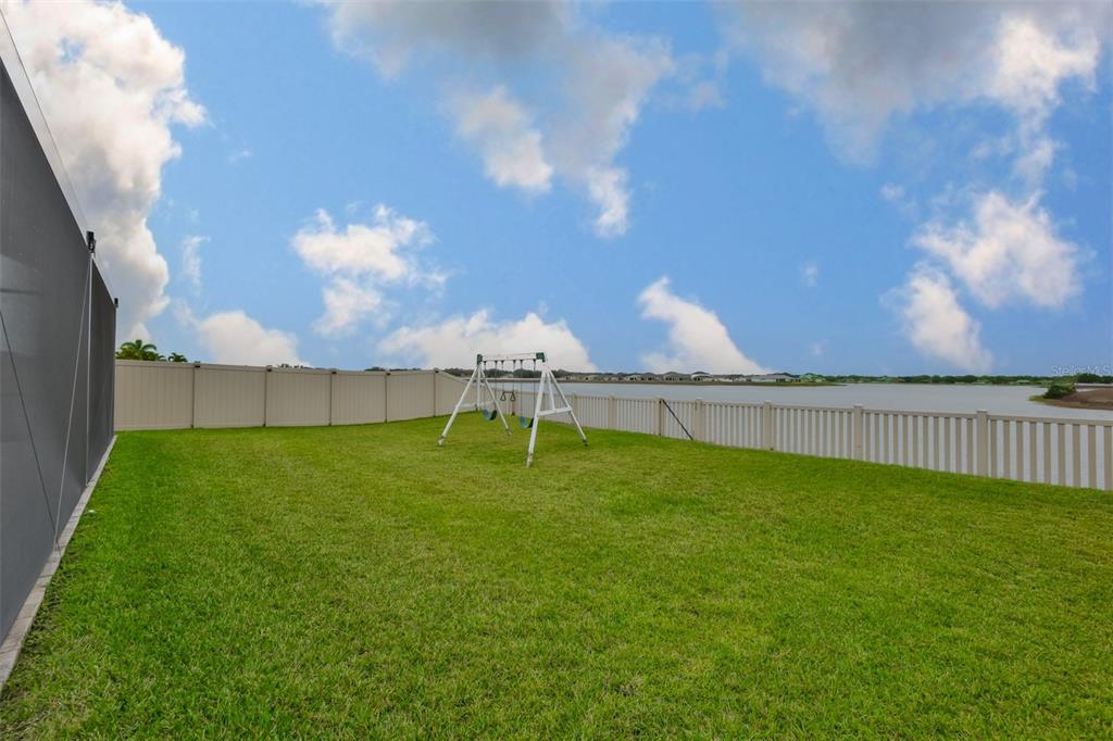 11454 Freshwater Ridge Drive Riverview, FL 33569 - Photo 53 of 65 a backyard of a house with table and chairs