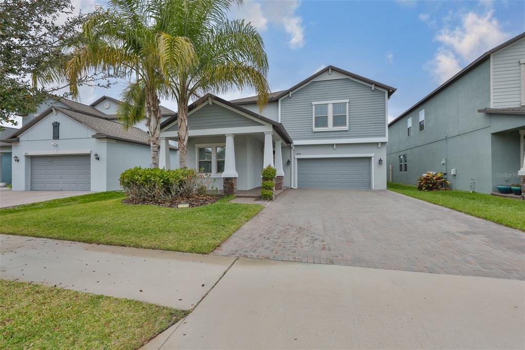 11454 Freshwater Ridge Drive Riverview, FL 33569 - Photo 6 of 65 a front view of a house with a garden and trees