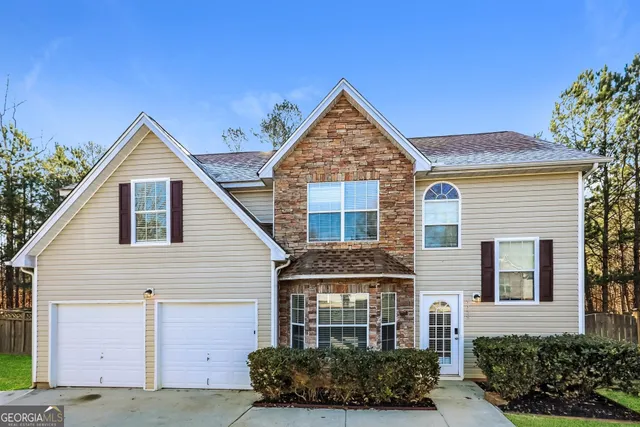 a front view of a house with a yard