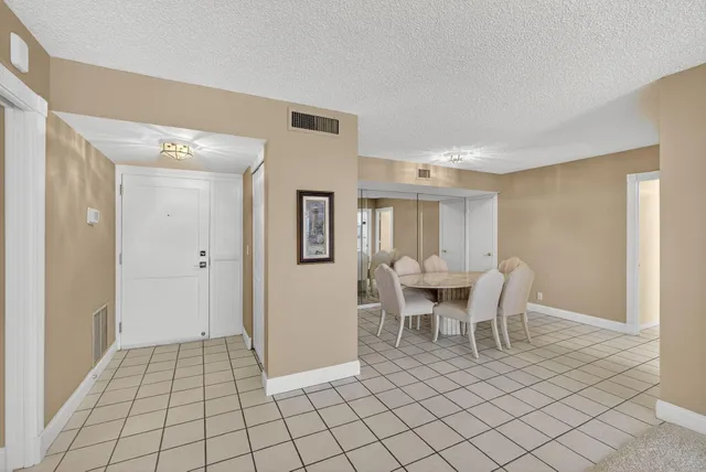a dining room with furniture a chandelier and wooden floor