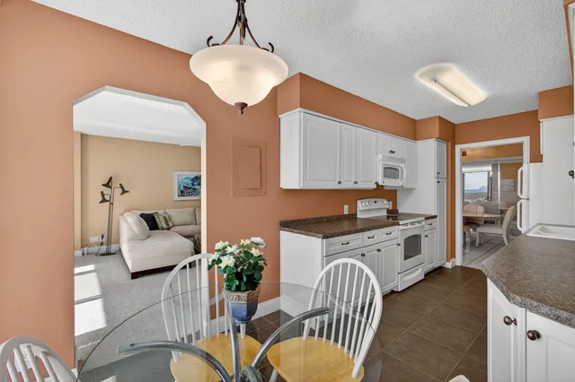 a white toilet sitting next to a shower