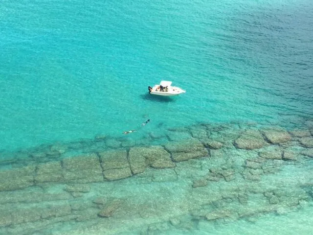 a bedroom with a bed and a lamp