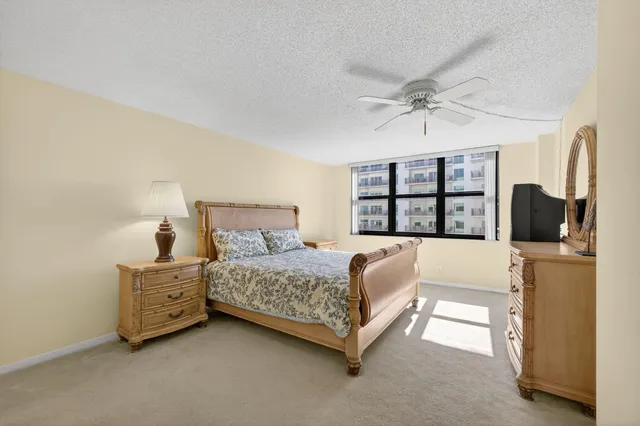 a bedroom with a bed and a large window