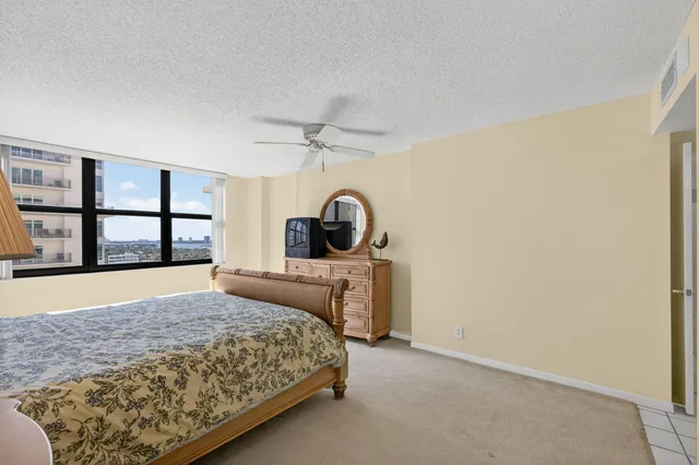 a spacious bedroom with a bed and a couch