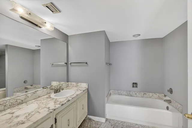 a front view of a building with garden and plants