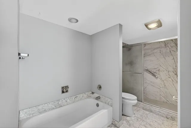 a room with furniture a large window and wooden floor