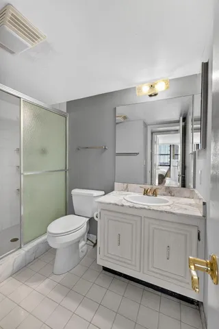 a living room with furniture a clock and a potted plant