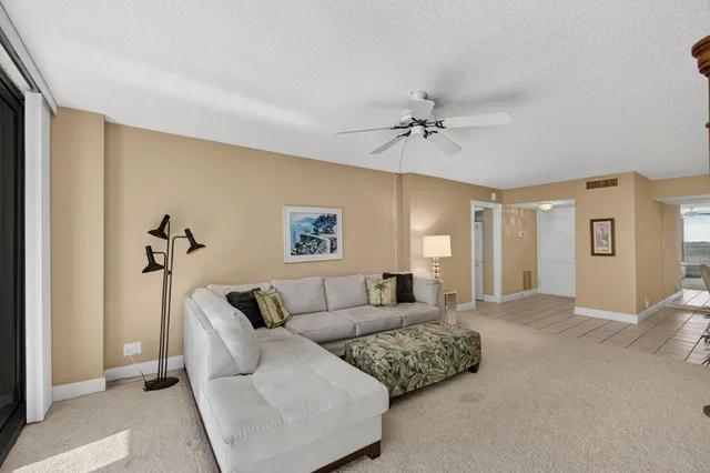 a dining room with furniture and chandelier fan
