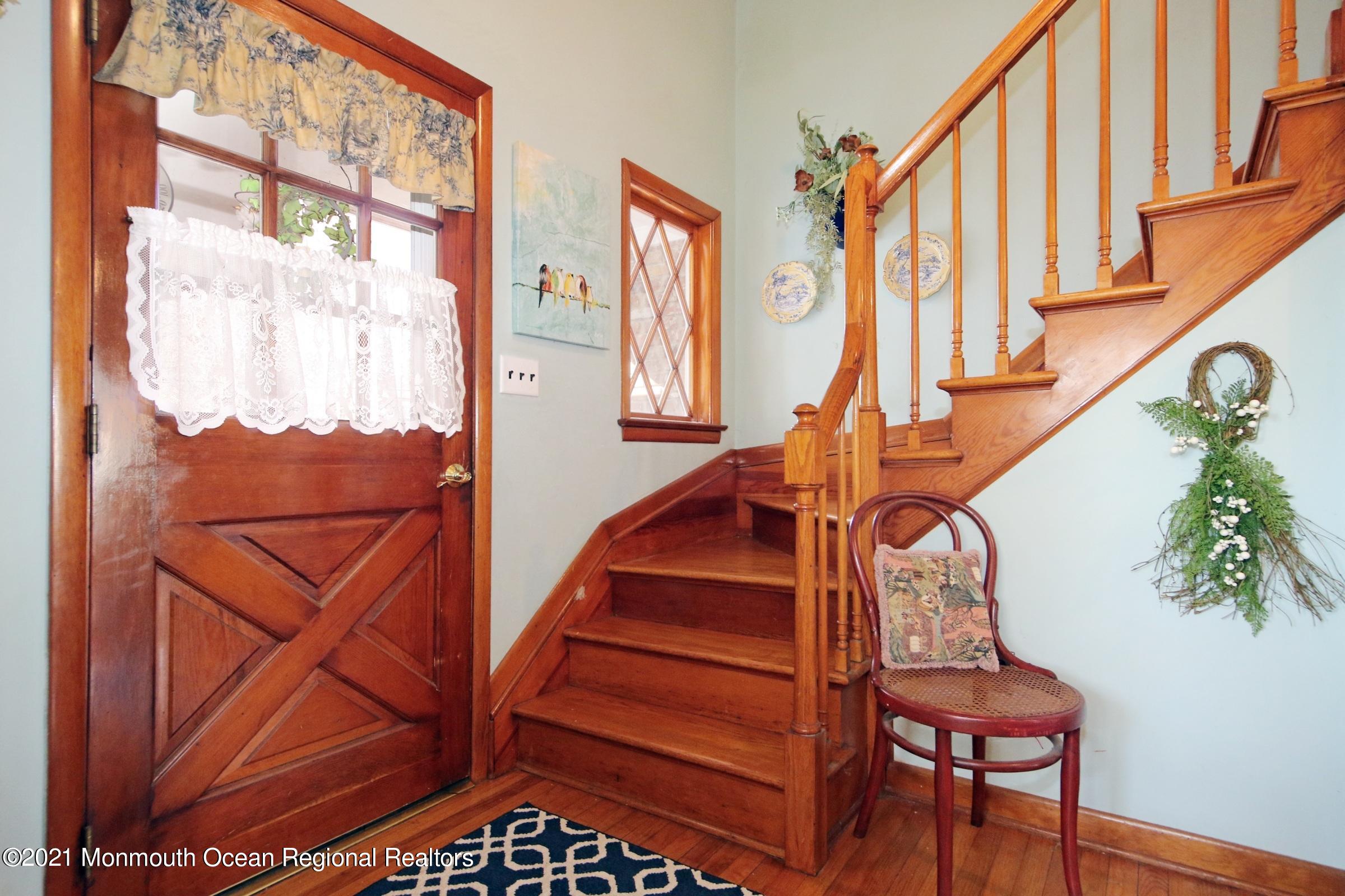 700 Hopping Road Belford, NJ 07718 - Photo 11 of 35 a view of staircase with railing and a potted plant