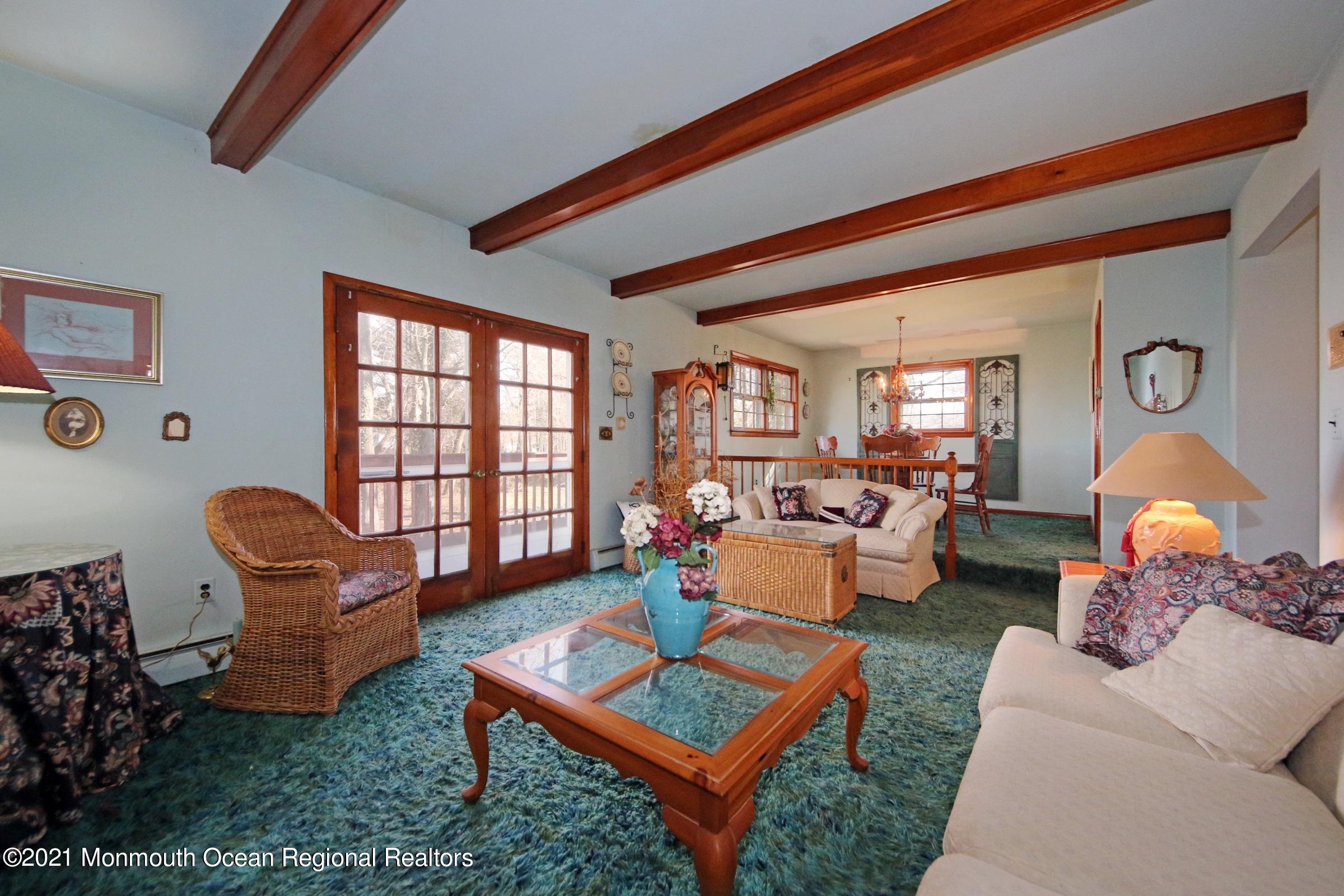 700 Hopping Road Belford, NJ 07718 - Photo 15 of 35 a living room with furniture a rug and a window