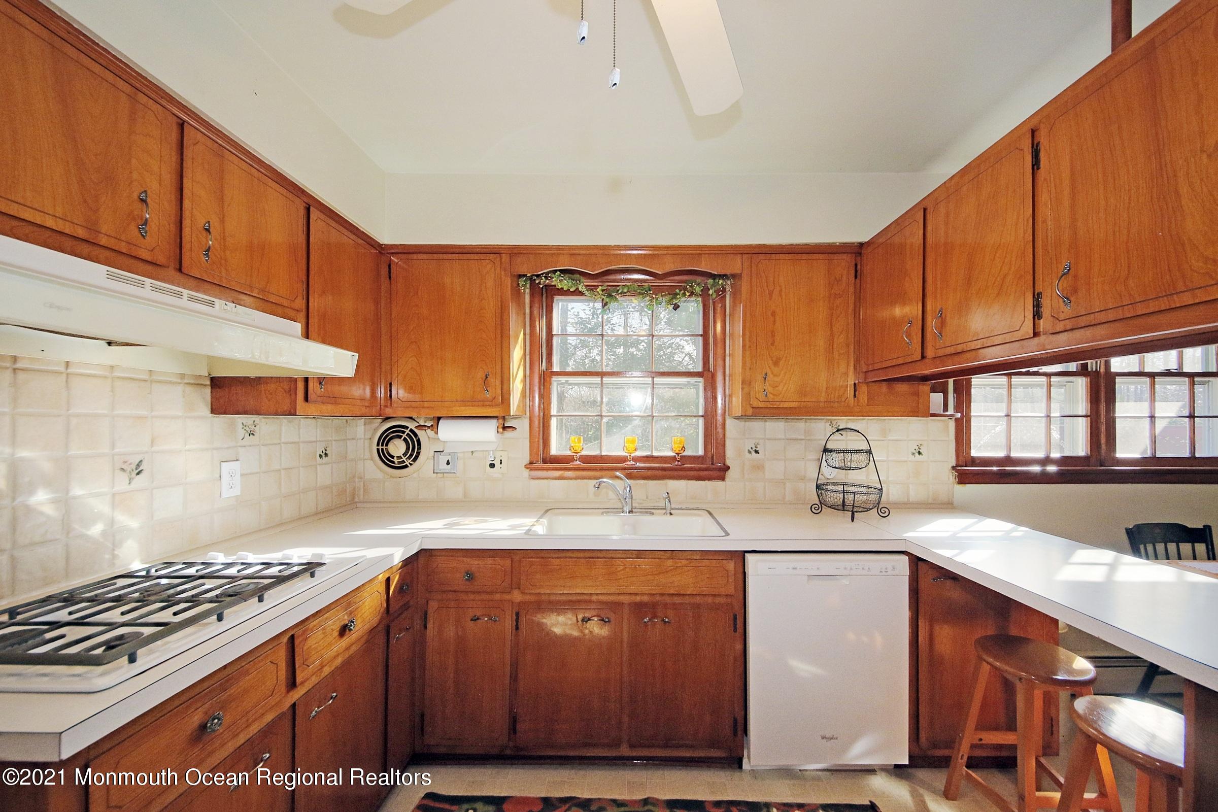 700 Hopping Road Belford, NJ 07718 - Photo 16 of 35 a kitchen with stainless steel appliances granite countertop a sink stove and cabinets