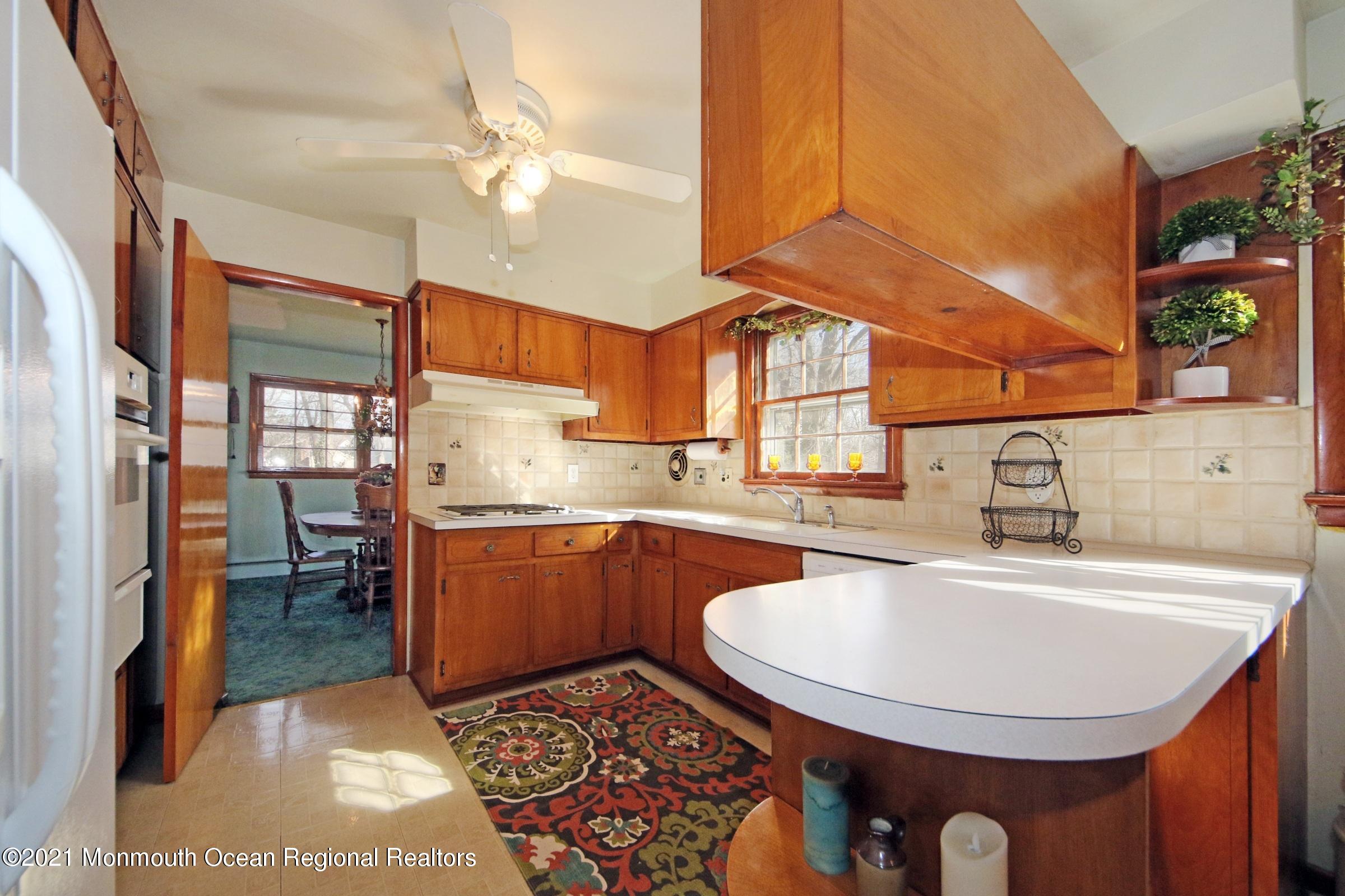 700 Hopping Road Belford, NJ 07718 - Photo 17 of 35 a kitchen with a sink cabinets and appliances