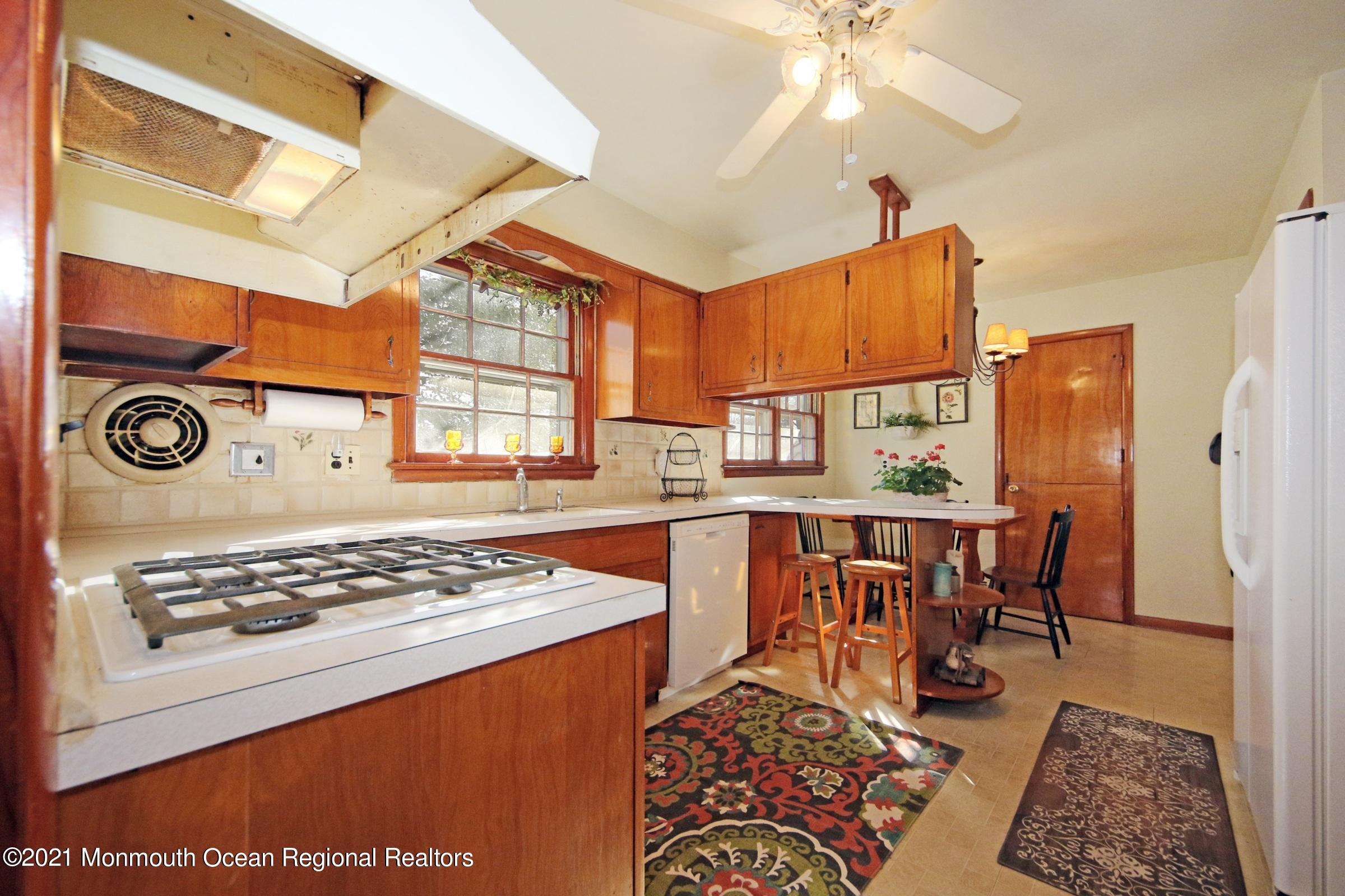 700 Hopping Road Belford, NJ 07718 - Photo 18 of 35 a view of kitchen with cabinets and window