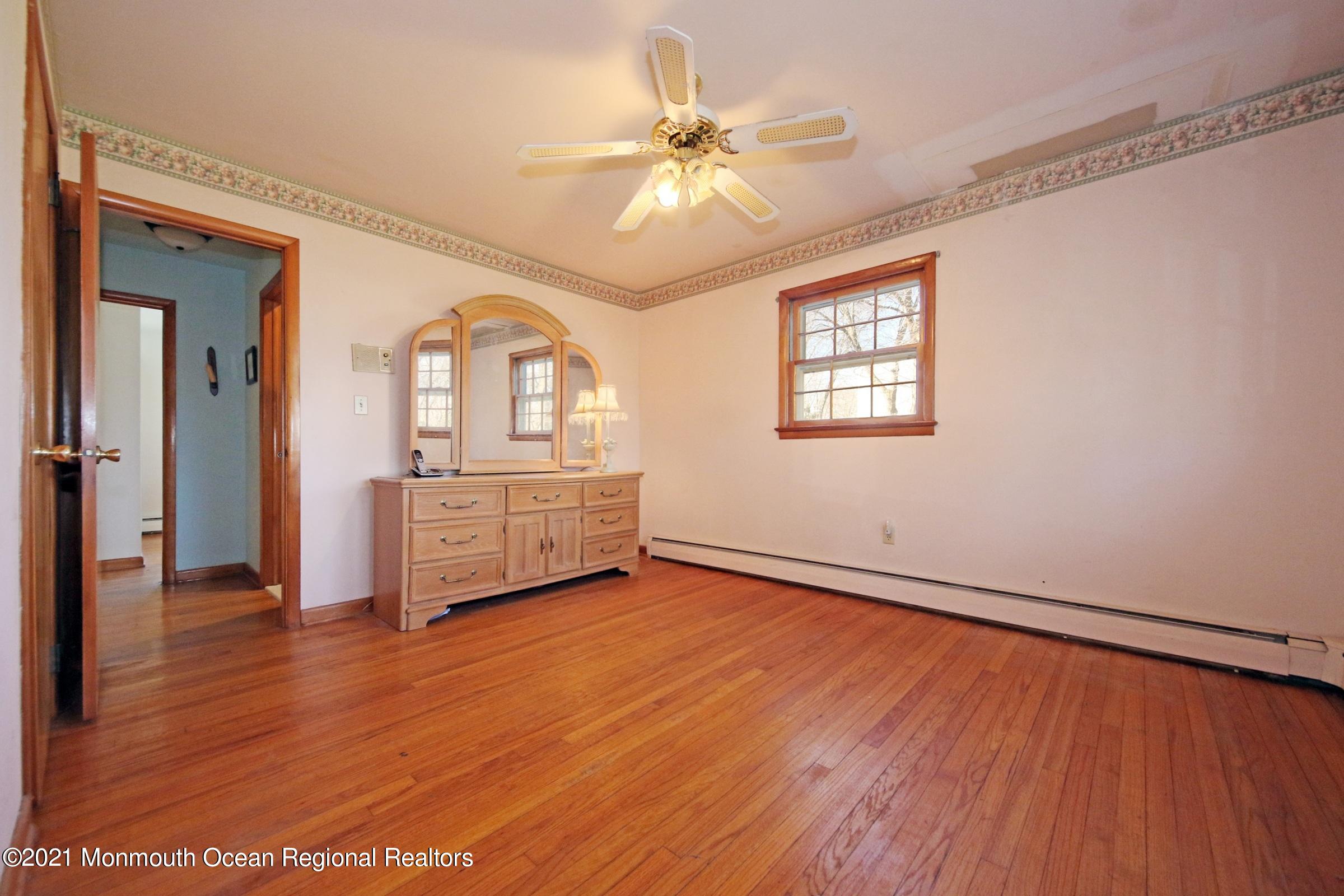 700 Hopping Road Belford, NJ 07718 - Photo 22 of 35 a view of an empty room with a window and wooden floor