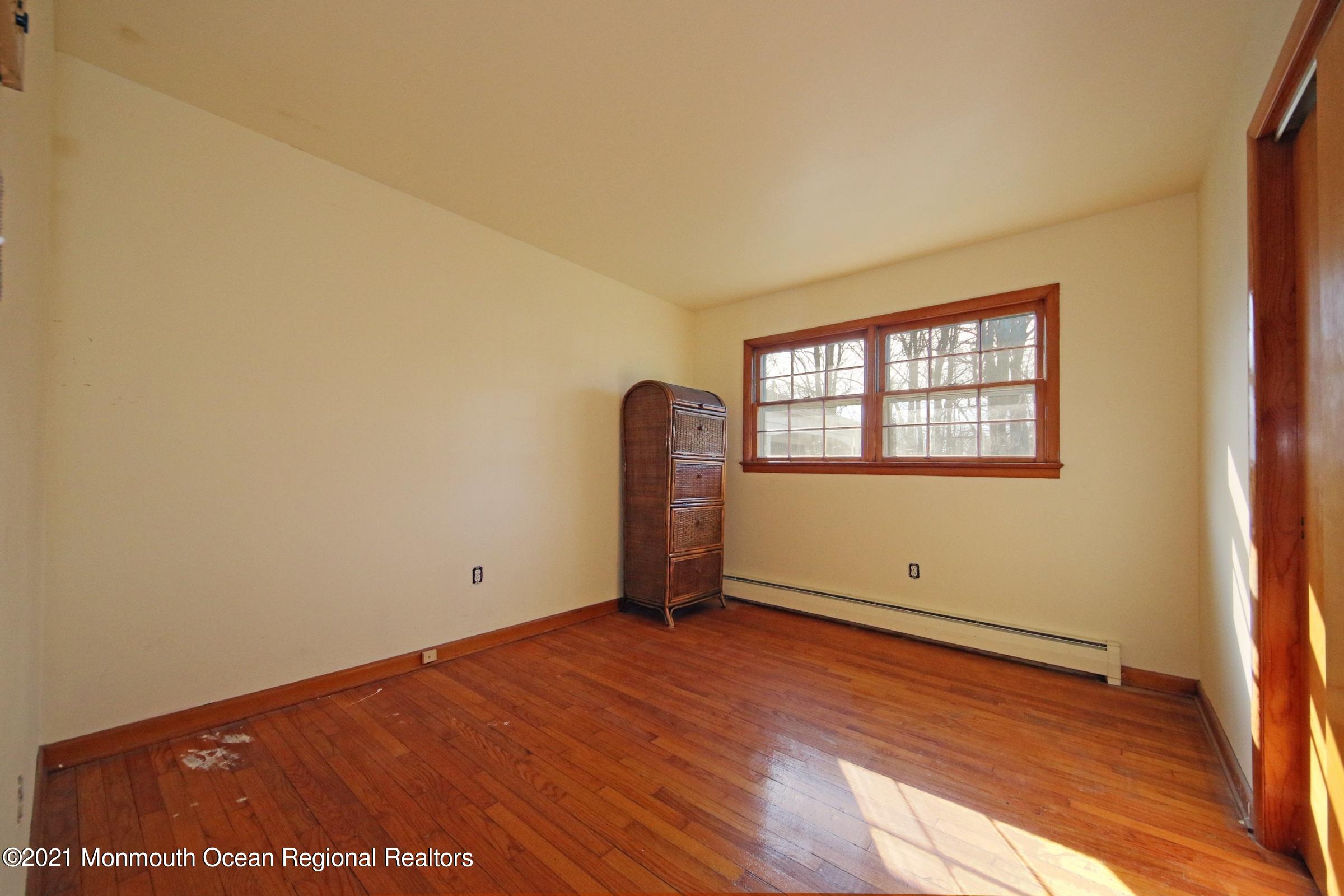 700 Hopping Road Belford, NJ 07718 - Photo 24 of 35 an empty room with wooden floor and windows