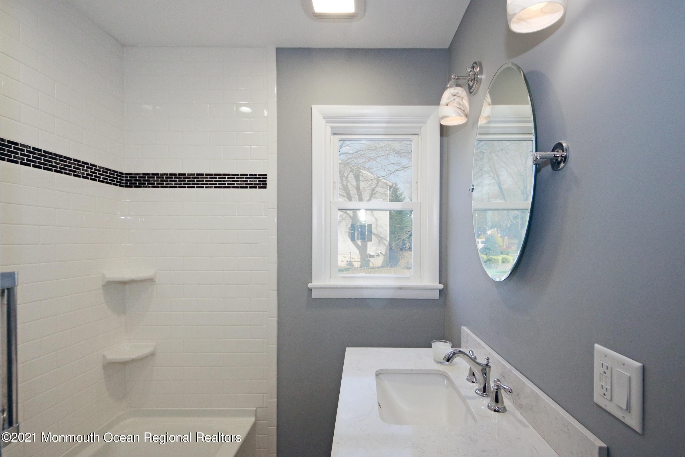 700 Hopping Road Belford, NJ 07718 - Photo 25 of 35 a bathroom with a sink and a mirror