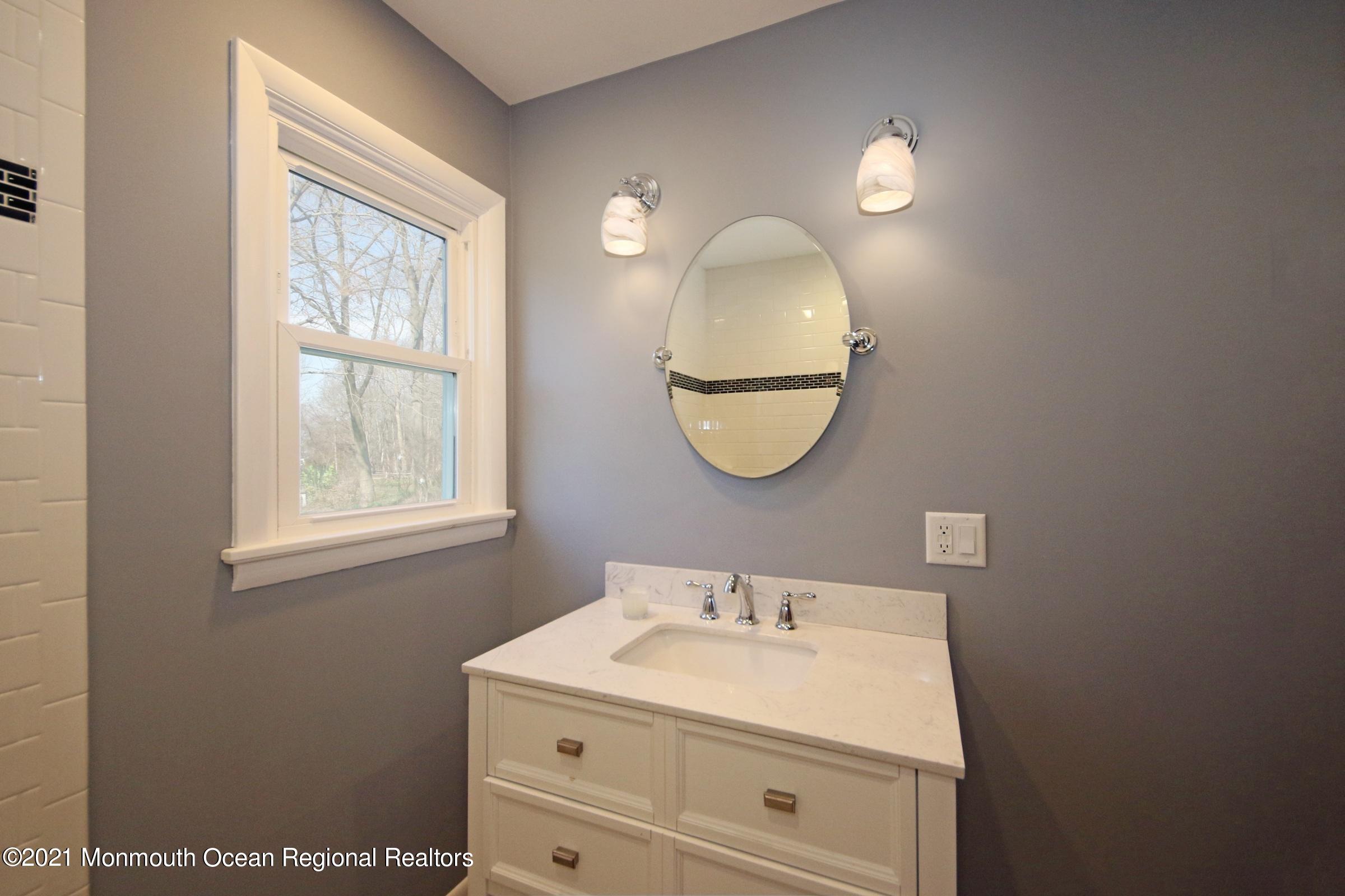 700 Hopping Road Belford, NJ 07718 - Photo 26 of 35 a bathroom with a sink mirror and a window