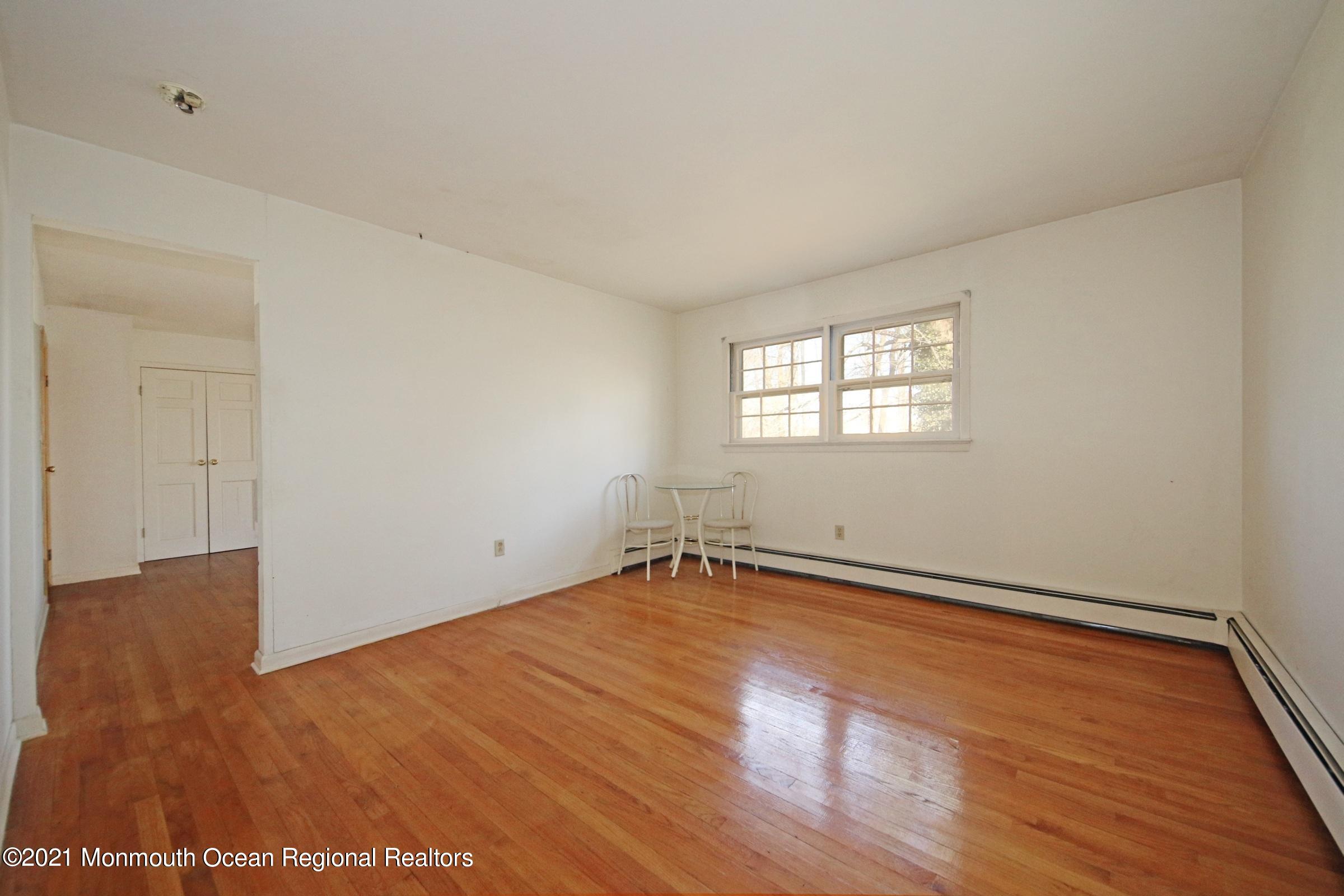 700 Hopping Road Belford, NJ 07718 - Photo 31 of 35 an empty room with wooden floor and windows