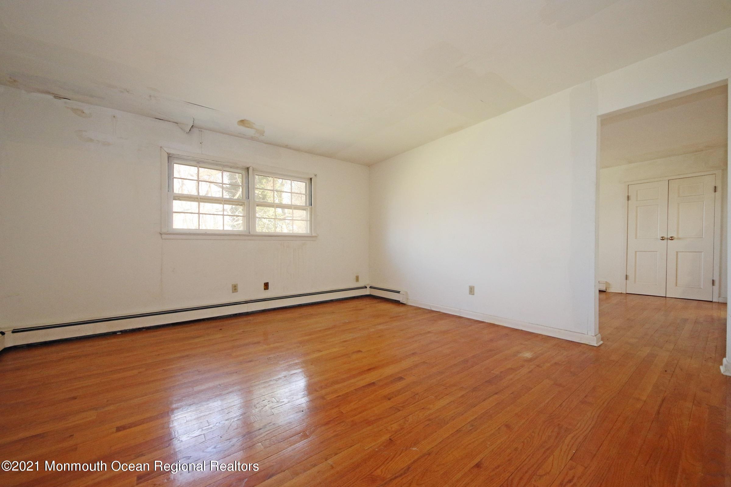 700 Hopping Road Belford, NJ 07718 - Photo 33 of 35 an empty room with wooden floor and windows