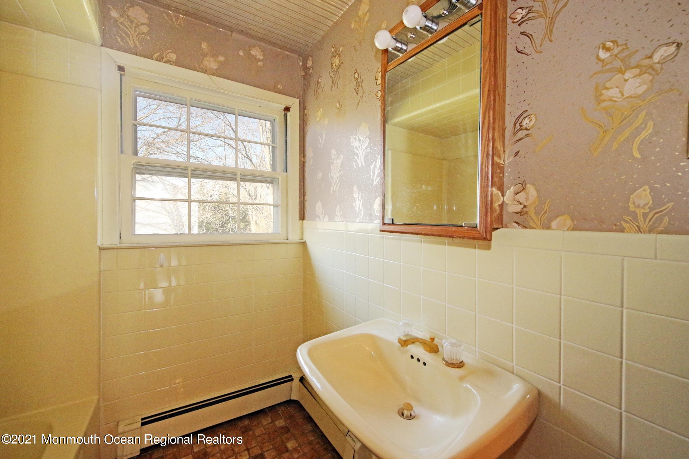 700 Hopping Road Belford, NJ 07718 - Photo 35 of 35 a bathroom with a sink a window and a shower