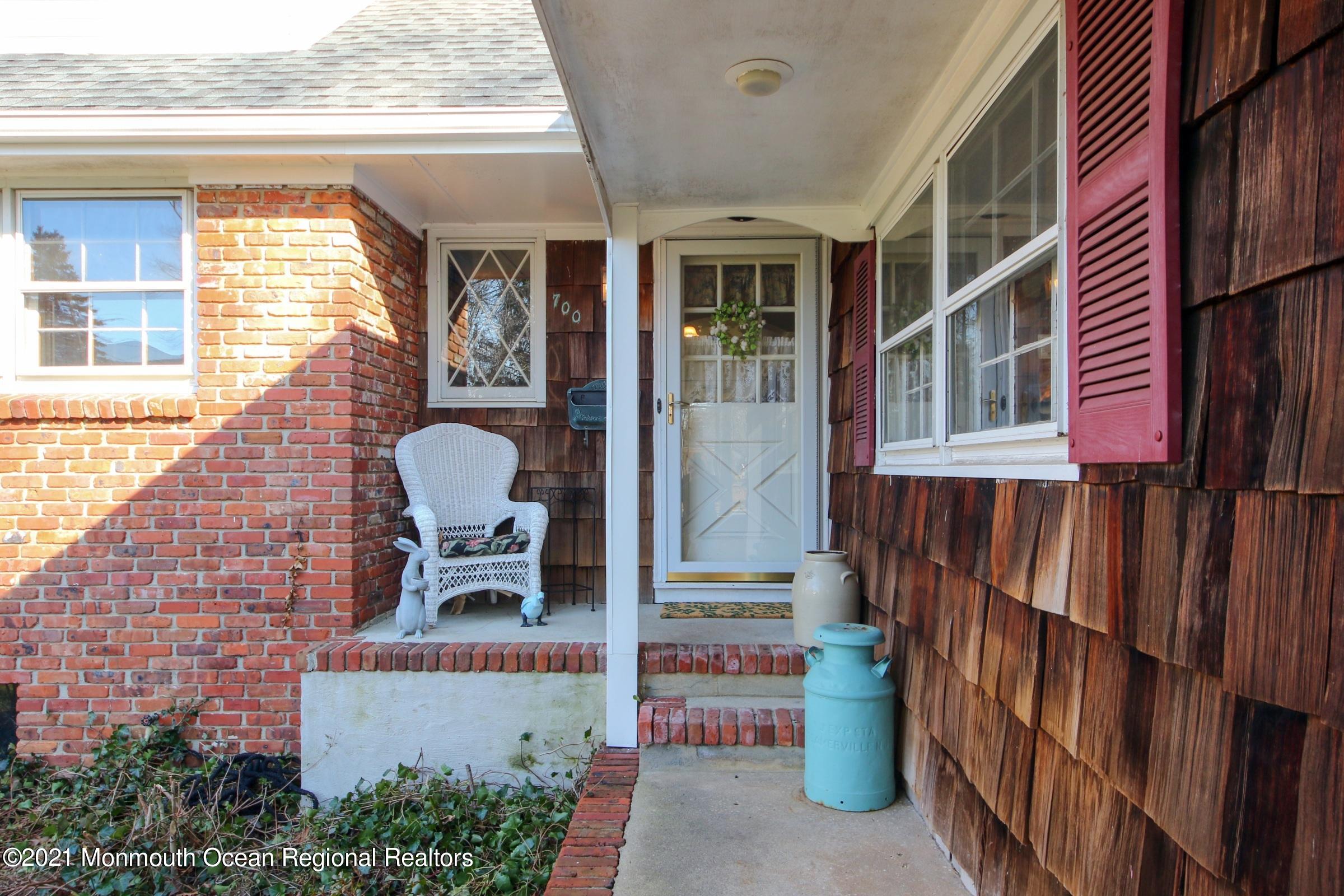 700 Hopping Road Belford, NJ 07718 - Photo 9 of 35 a front view of a house with outdoor seating