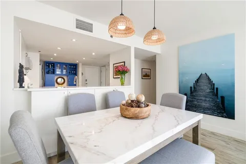 a living room with dining table and chairs