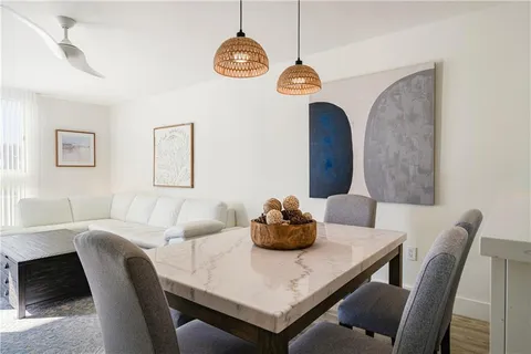 a dining room with furniture and window