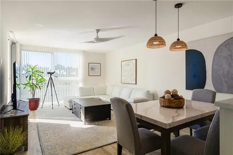 a living room with kitchen island furniture and a chandelier
