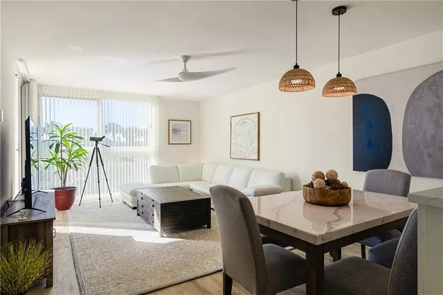 a living room with kitchen island furniture and a chandelier