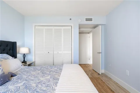 a bedroom with a bed and a toilet