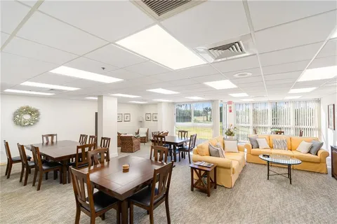 a living room with lots of furniture and a large window