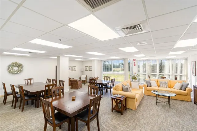 a living room with lots of furniture and a large window