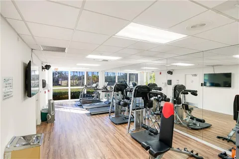 a living room with lots of furniture and gym equipment