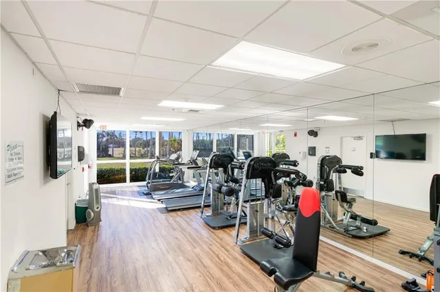 a living room with lots of furniture and gym equipment