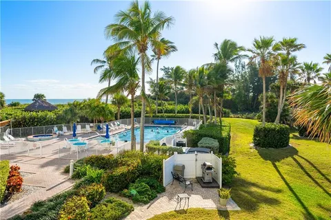 a view of a swimming pool with lounge chairs
