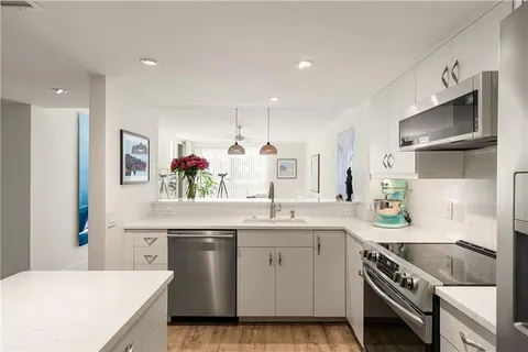 a kitchen with a sink stove and cabinets