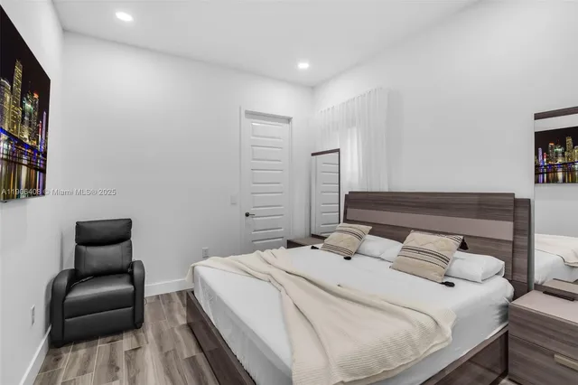 a bedroom with a bed and a chair