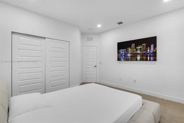 a bathroom with a sink a toilet a mirror and shower