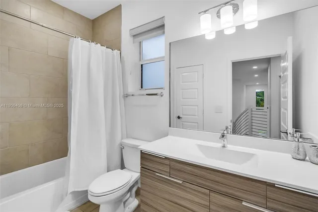 a living room with patio furniture and a potted plant