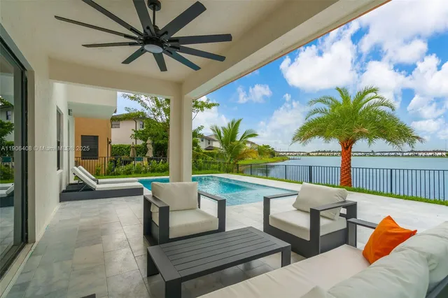 a view of a patio with a table and chairs under an umbrella