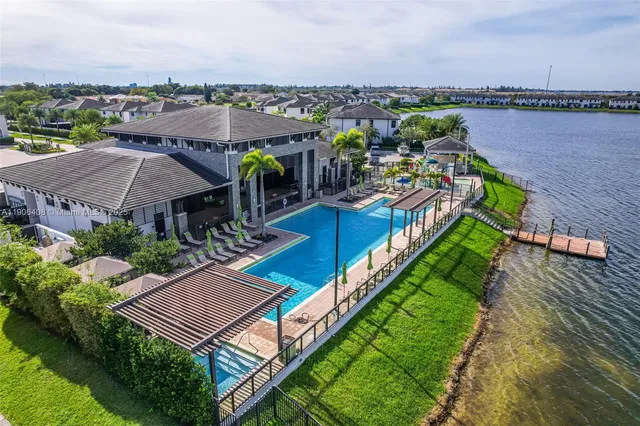 an aerial view of a house with swimming pool and ocean view