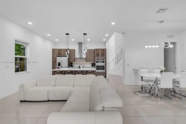 a living room with furniture and kitchen view