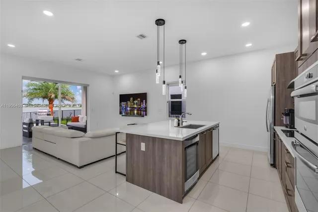 a kitchen with kitchen island cabinets and refrigerator