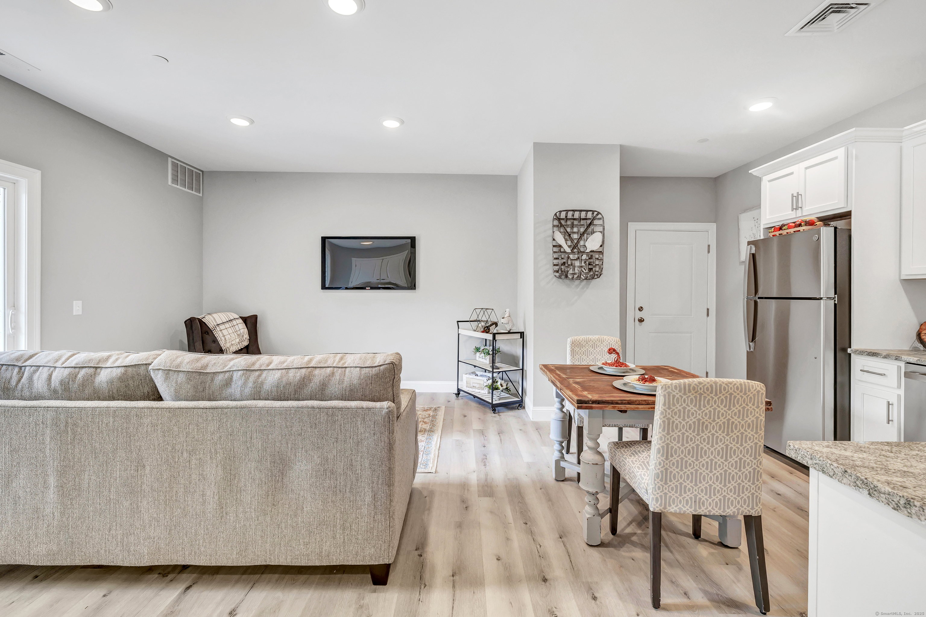 303 Bridgeport Avenue, Unit 205 Shelton, CT 06484 - Photo 13 of 36 a living room with furniture and a refrigerator