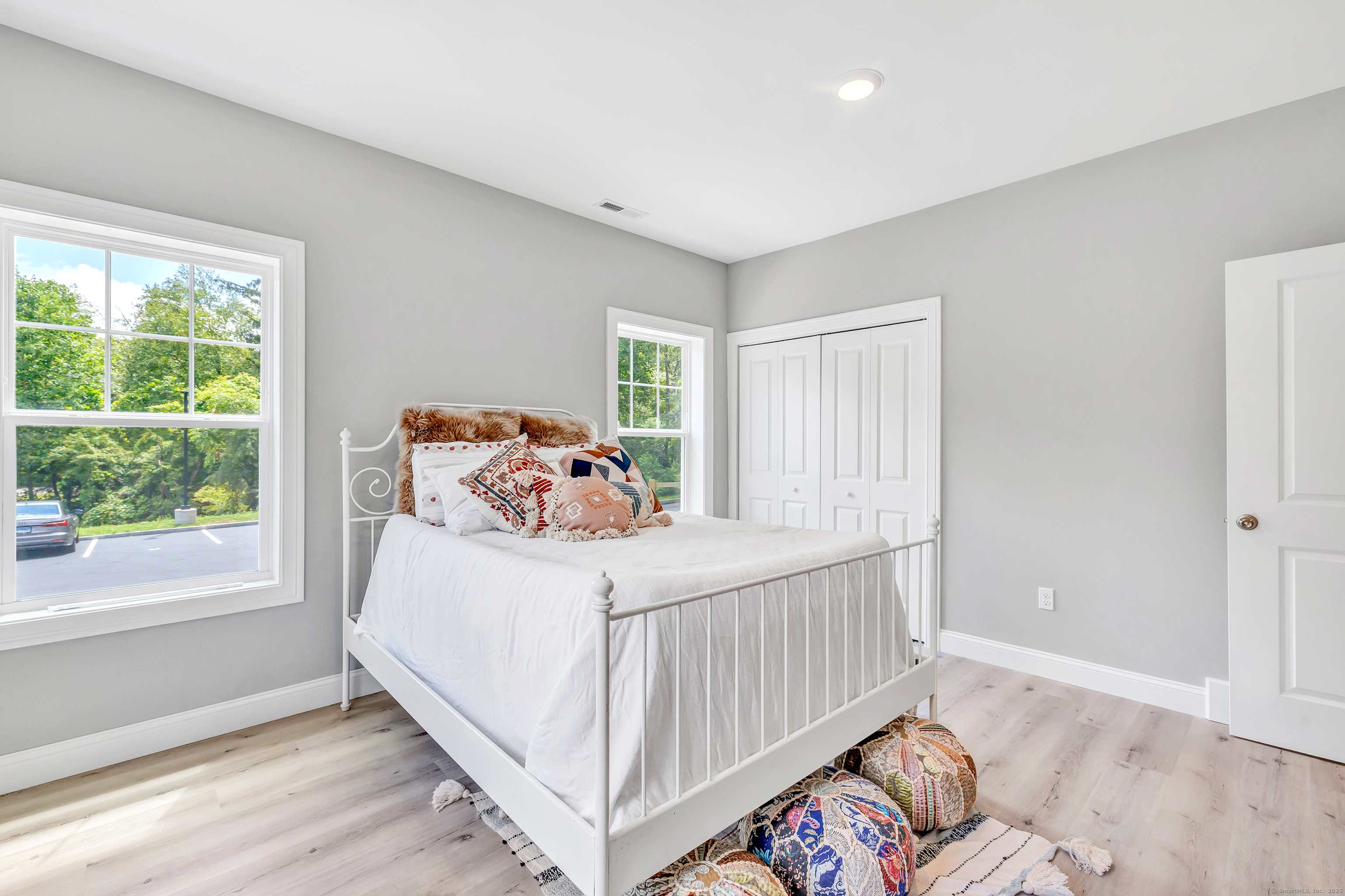 303 Bridgeport Avenue, Unit 205 Shelton, CT 06484 - Photo 17 of 36 a bedroom with a bed and wooden floor