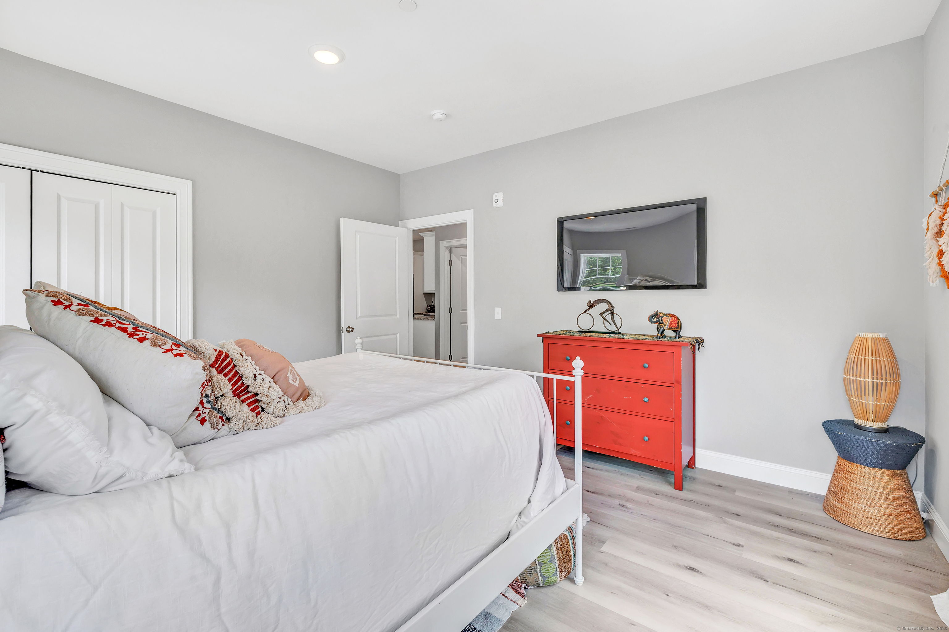 303 Bridgeport Avenue, Unit 205 Shelton, CT 06484 - Photo 18 of 36 a bedroom with bed and flat screen tv