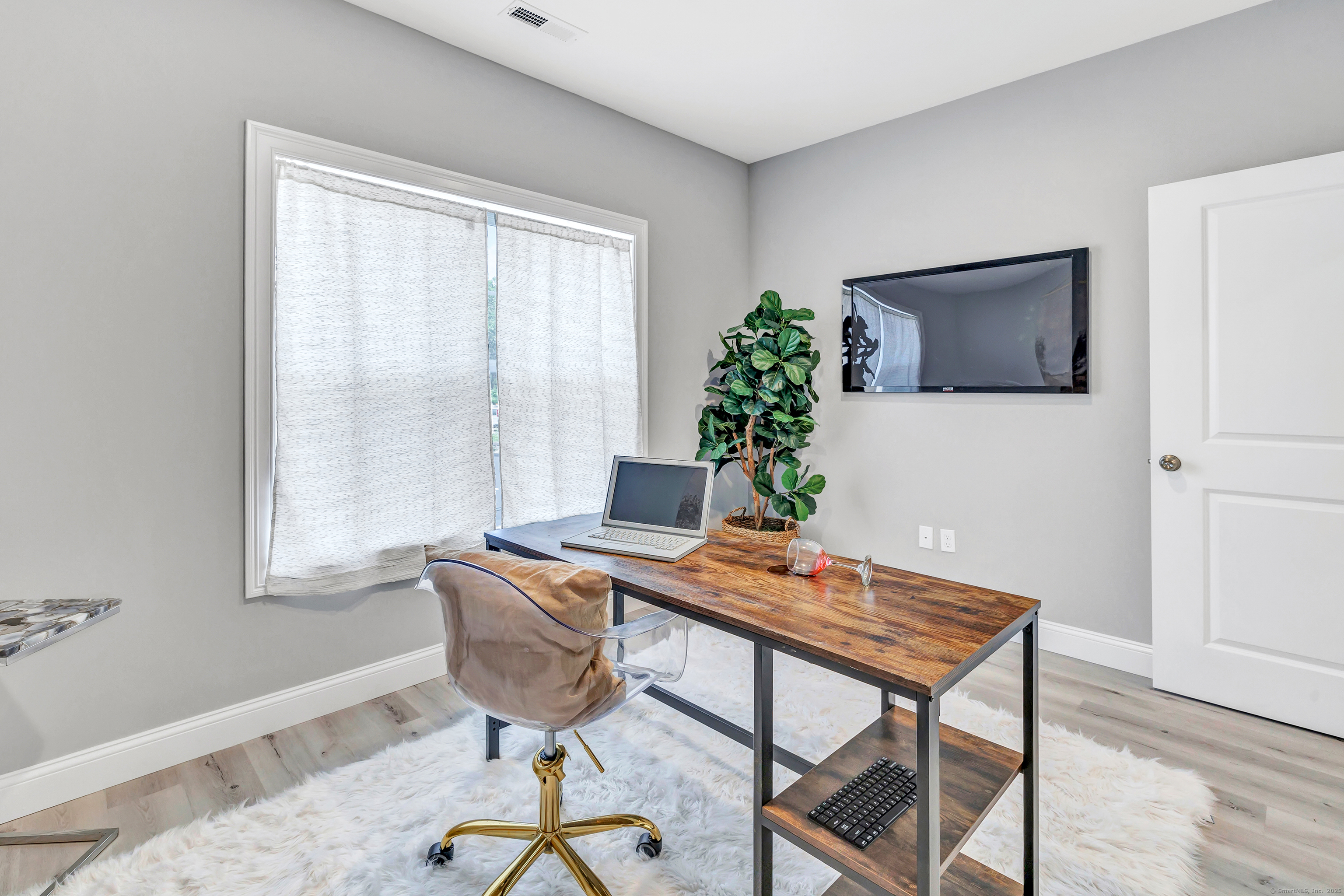 303 Bridgeport Avenue, Unit 205 Shelton, CT 06484 - Photo 22 of 36 a view of a workspace with furniture and window in a room