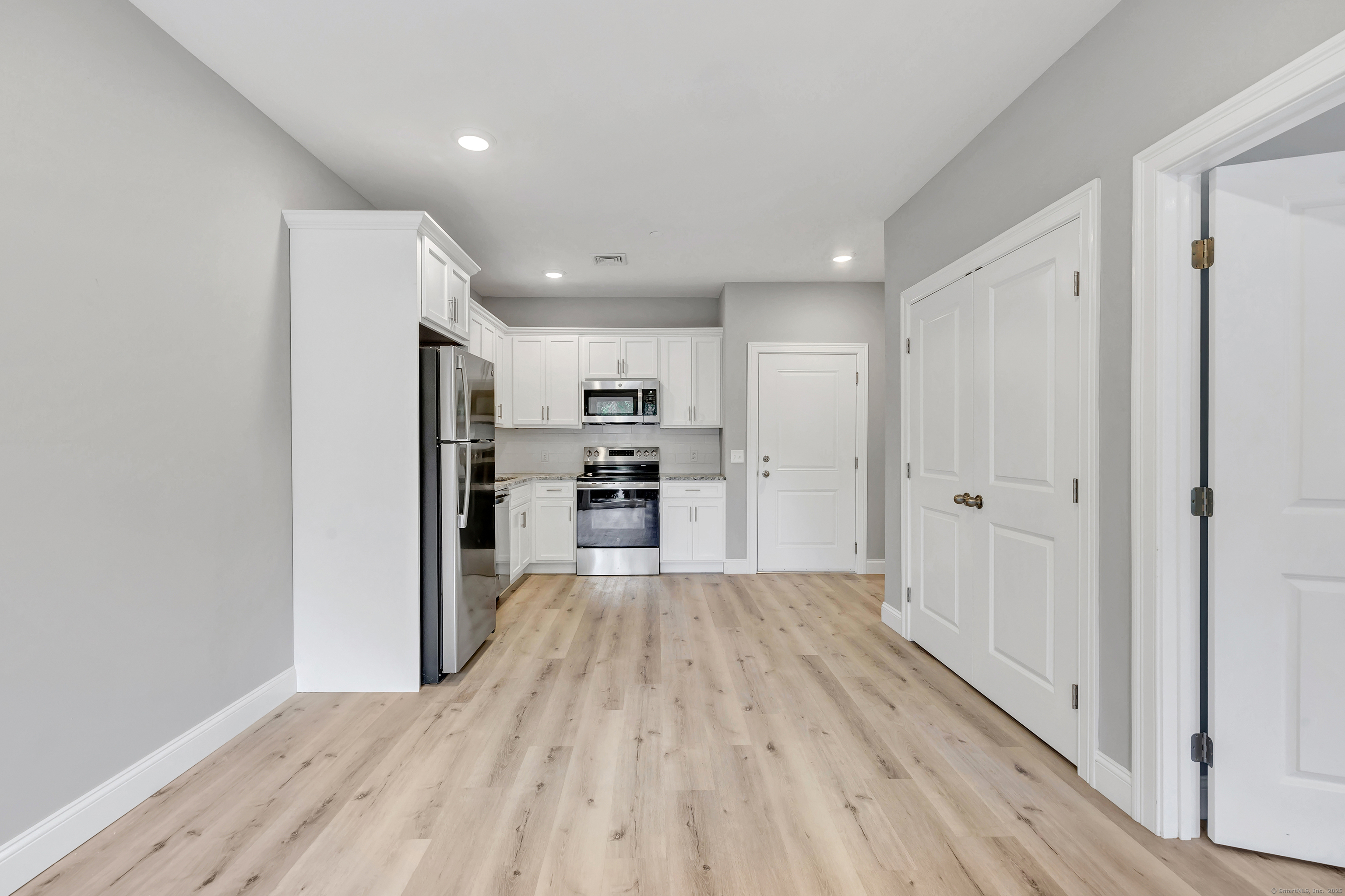 303 Bridgeport Avenue, Unit 205 Shelton, CT 06484 - Photo 27 of 36 a view of kitchen with wooden floor